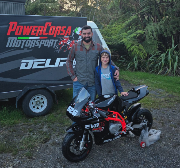 James Drought with his pit bike in front of the PowerCorsa Motorsport trailer